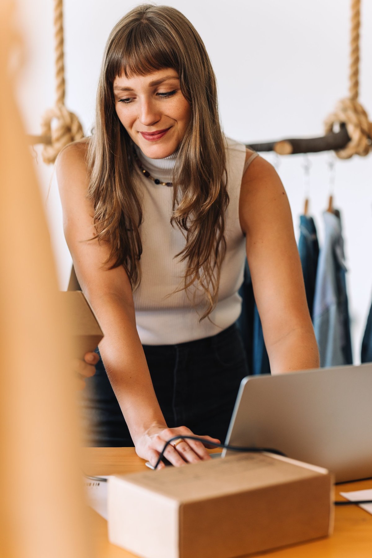 Business owner preparing online orders in a clothing shop